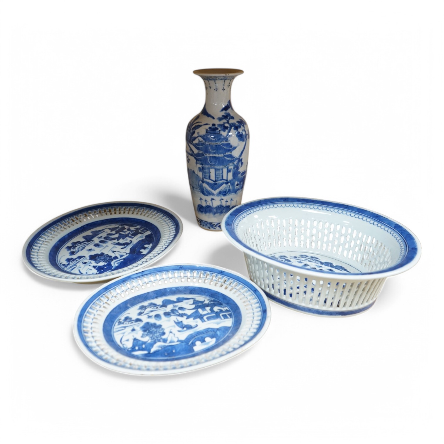 An early 19th century Chinese export blue and white chestnut dish, two related stands and a similar vase, largest 26cm high. Condition - fair
